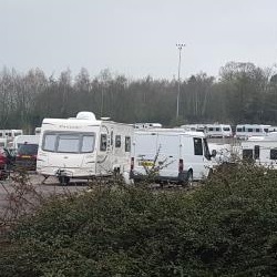 Travellers camped on road embankment