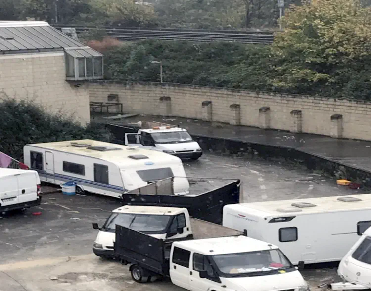 caravans and vehicles parked in building yard