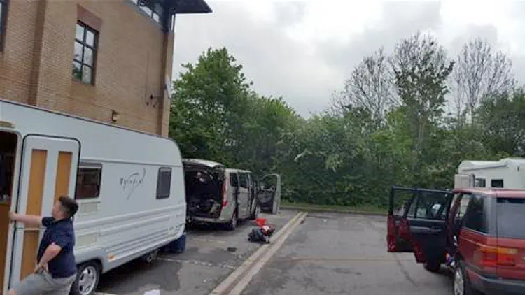 Travellers on office car park